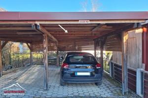 a car is parked under a covered garage at Apartment LICHTENSTERN in Oberau