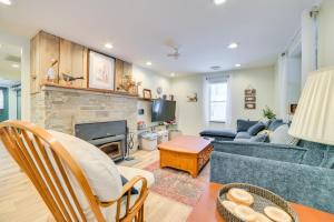 a living room with a couch and a fireplace at 9 Mi to Snowmobile Trails! Home Near Mullett Lake in Cheboygan