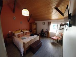 a bedroom with a bed in a room with a wooden ceiling at Au granit bleu in Faye-lʼAbbesse