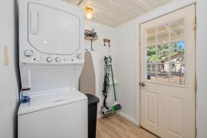 a laundry room with a washer and dryer and a door at Main Street in Templeton