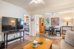 a living room with a large television and a table at 7th Street Sanctuary in Paso Robles