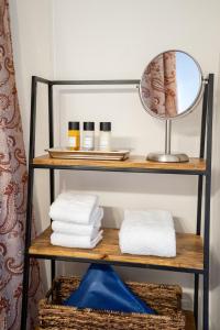 a shelf with towels and a mirror in a bathroom at 7th Street Sanctuary in Paso Robles +23 photos