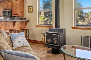 a living room with a couch and a stove at Vita Amorosa in Atascadero