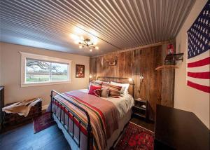 a bedroom with a bed with an american flag on the wall at Vaquero Verano in Templeton +66 photos