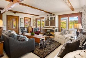 a living room with couches and a table at Vineyard Retreat in Templeton