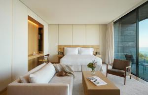 a hotel room with a bed and a couch at Akelarre - Relais & Châteaux in Donostia-San Sebastián +37 photos