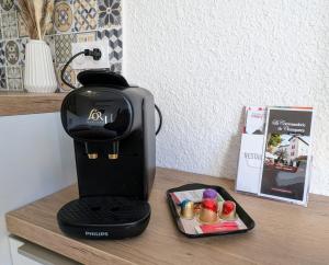 a black coffee maker sitting on a counter at Studio le Cosy - Bourgoin Centre in Bourgoin +7 photos
