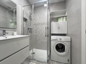 a bathroom with a washing machine and a sink at Apartamento Verdemar in Suances +21 photos