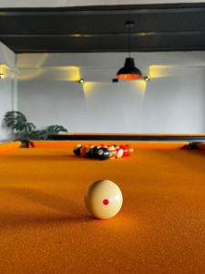 a cue ball on the floor of a pool table at San Gabriel Via Termales Santa Rosa in Santa Rosa de Cabal