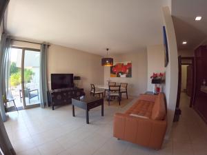 a living room with a couch and a table at Oasis by Templesuites - Praia da Rocha in Portimão