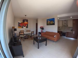a living room with a couch and a table at Oasis by Templesuites - Praia da Rocha in Portimão