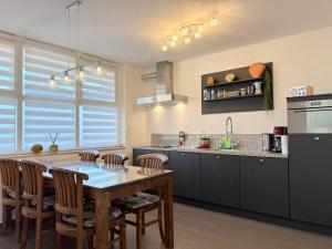 a kitchen with a wooden table and chairs and a counter at Studio Apartment Harbour Pula in Pula +23 photos