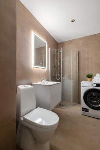 オスロにあるDINBNB Apartments Enjoy a stylish stay in the heart of the cityのバスルーム(トイレ、洗面台、洗濯機付)