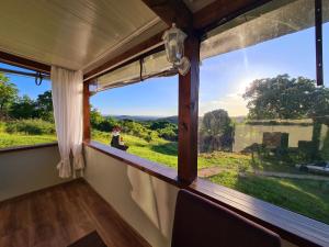 a window in a room with a view of a field at Vila Zornica in Kondolovo +9 photos