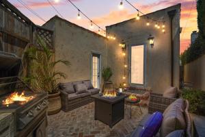 a patio with a couch and a table and a stove at Belmont Shore Escape - Arcades - FirePit - Beach - Parking in Long Beach