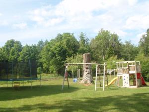 a playground with a tree and a swing at Pauka Holiday House in Palli