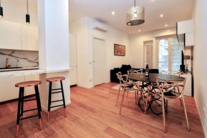 a kitchen and dining room with a table and chairs at Cozy Apartment between Sempione, City Life and MiCo ! in Milan