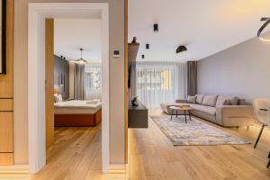 a living room with a couch and a bed at B-Holiday Luxury Apartments Urban Plaza in Braşov +189 photos