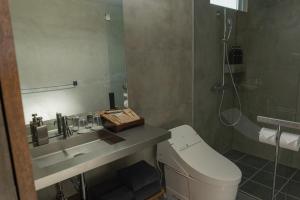a bathroom with a toilet and a sink and a shower at Bagus in Nakijin +19 photos