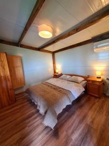 a bedroom with a large bed with two lamps on it at Vila Zornica in Kondolovo
