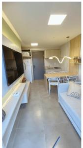 a living room with a couch and a table at Lindo Apartamento no Centro de Porto de Galinhas in Porto De Galinhas