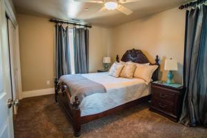 a bedroom with a large bed with a wooden headboard at Baby Bliss in Paso Robles