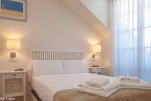 Ένα ή περισσότερα κρεβάτια σε δωμάτιο στο AV Gijón San Agustín 12