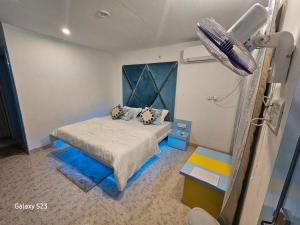 a bedroom with a bed with a blue head board at Last Minute Deal @ Hotel Sunset in Orchha