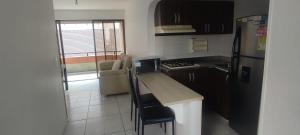 a small kitchen with a counter and a refrigerator at 2 Bedroom 1 Bathroom Cabecera with Doorman in Bucaramanga +14 photos