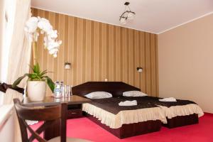 Кровать или кровати в номере Hotel Podzamcze