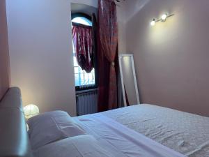 Ένα ή περισσότερα κρεβάτια σε δωμάτιο στο La Casa di Nonna Bice