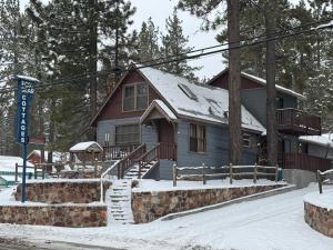 a house with snow on the ground in front of it at Fox n Bear Cottages Big Bear in Big Bear Lake