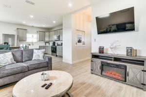 a living room with a couch and a fireplace at Modern Port Isabel Home Coastal Family Home! in Port Isabel