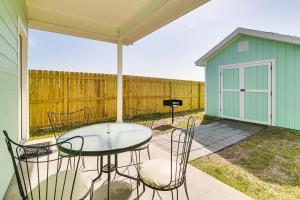a patio with a table and chairs and a shed at Modern Port Isabel Home Coastal Family Home! in Port Isabel