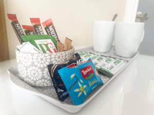 a shelf with a basket of snacks on a table at Esk Vale Guest House in Portsmouth