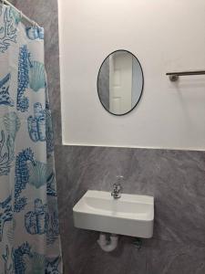 a bathroom with a sink and a mirror at 60 On Kosmos in Bellville South +10 photos
