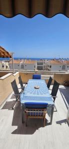 a blue table and chairs on a roof at CostaBlanca Sunrise in Arenales del Sol