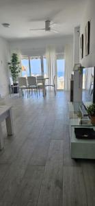 a living room with a table and a dining room at CostaBlanca Sunrise in Arenales del Sol