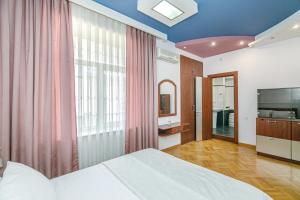 a bedroom with a bed and a large window at STELLA Luxury Apartment in Nizami street in Baku +120 photos