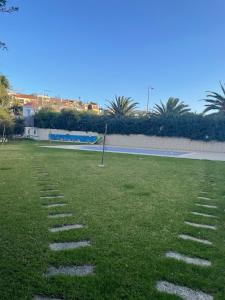 a grass field with stepping stones in a park at Luxury Appartment Beach in Tangier