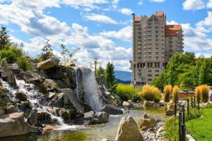 a waterfall in a park with a building in the background at Renovated Studio 5 Min from Scenic Lake CDA - Pet Friendly in Coeur d'Alene