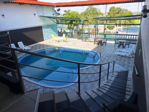 a large swimming pool with a slide in a building at Hotel Safari in Iquitos