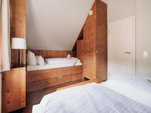a bedroom with two beds with wooden walls at Ferienhaus in Schierke for 6 Personen in Schierke