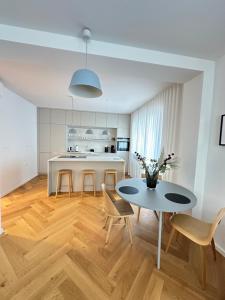 a kitchen and dining room with a table and chairs at Bratislava OLDTOWN Apartment 130m2 ,60m2 terrace and 2 bathrooms in Bratislava