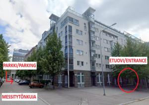 a large white building with a red circle in front of it at Two-room apartment in the center of Helsinki with a sauna! Free parking! in Helsinki