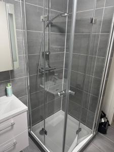 a shower with a glass door in a bathroom at Monteurwohnung bis zu 6 Personen in Ottweiler