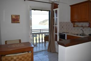 a kitchen with a view of the ocean from a balcony at Seasound in Agios Stefanos