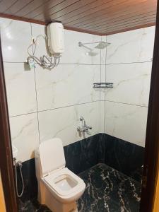 a bathroom with a toilet and a sink at VVP Rooms in Cochin