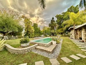 a swimming pool in a yard with a landscaping at Tarentaal Guest Farm Etosha National Park Namibia in Okaukuejo