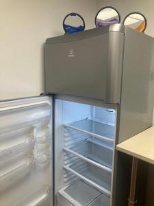 an empty refrigerator with its door open in a kitchen at Posada Rancho Malcaminos in Tabernas